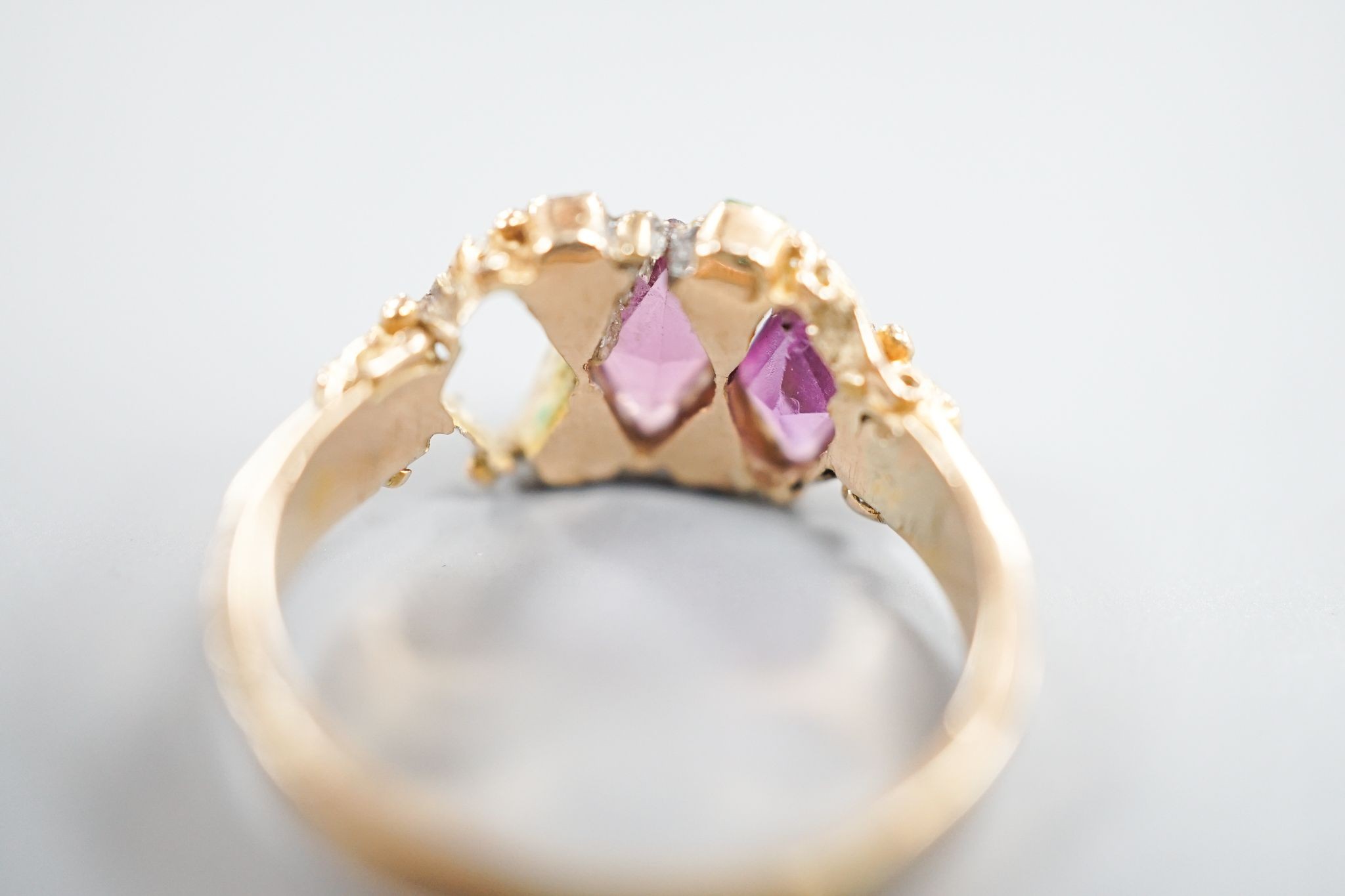 A late Victorian 15ct gold, garnet and emerald set dress ring(stone missing & stone replacement?), size L, gross 2.2grams.